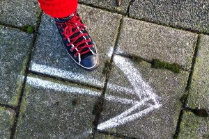 foot next to chalked arrow